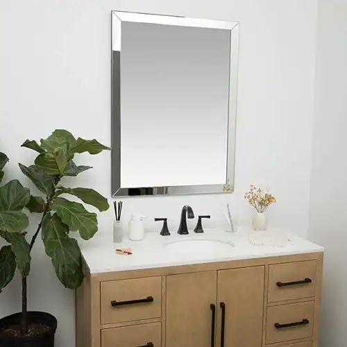 Framed mirror in Bunbury bathroom hanging above a sinl