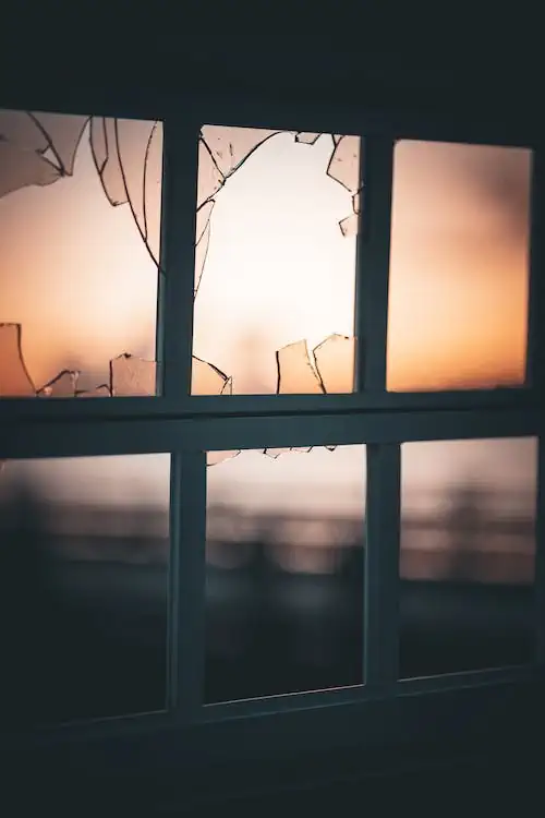 A broken window and shattered glass
